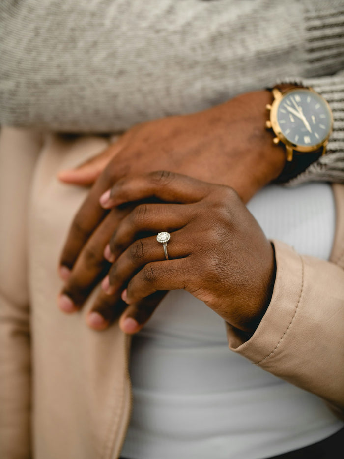 Person wearing a gold ring and a silver ring side by side