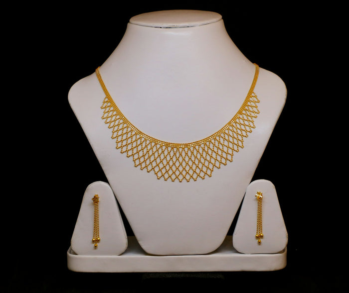 Gold necklace and matching earrings displayed as a gift set