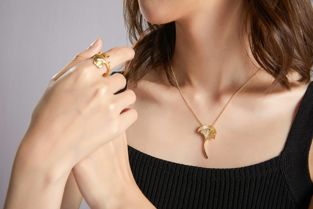 Woman wearing layered gold necklaces
