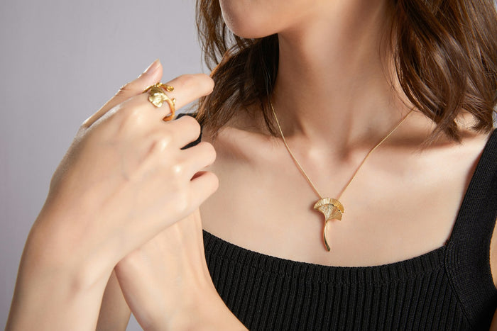 Woman wearing layered gold necklaces